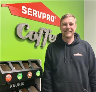 Male with green background with SERVPRO Cafe words