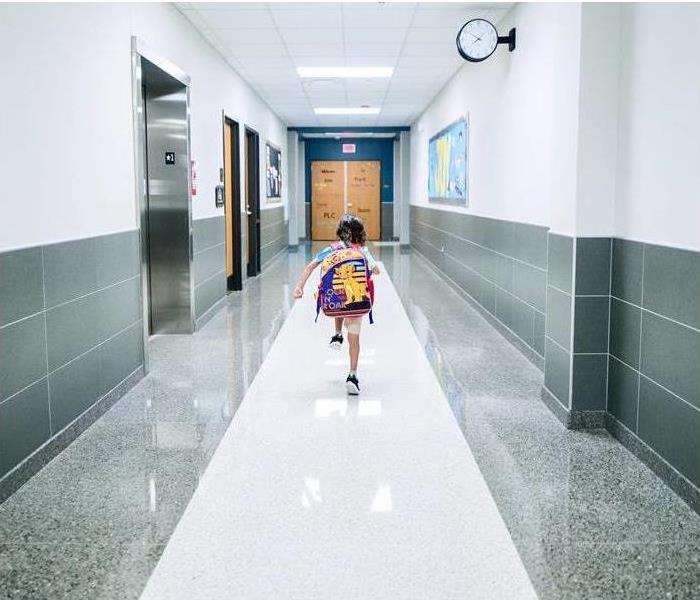 a student walking down school hallway