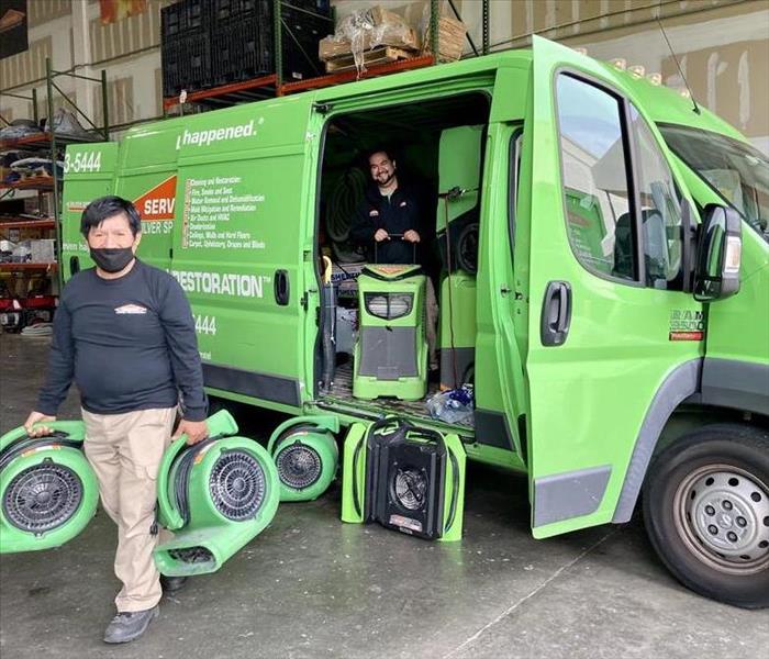 2 men with green van & equipment