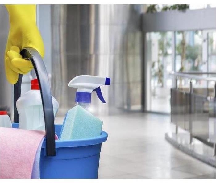 cleaning supplies with offices in background