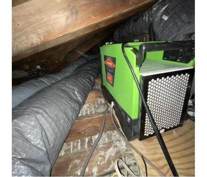 Green dryer fan in crawl space